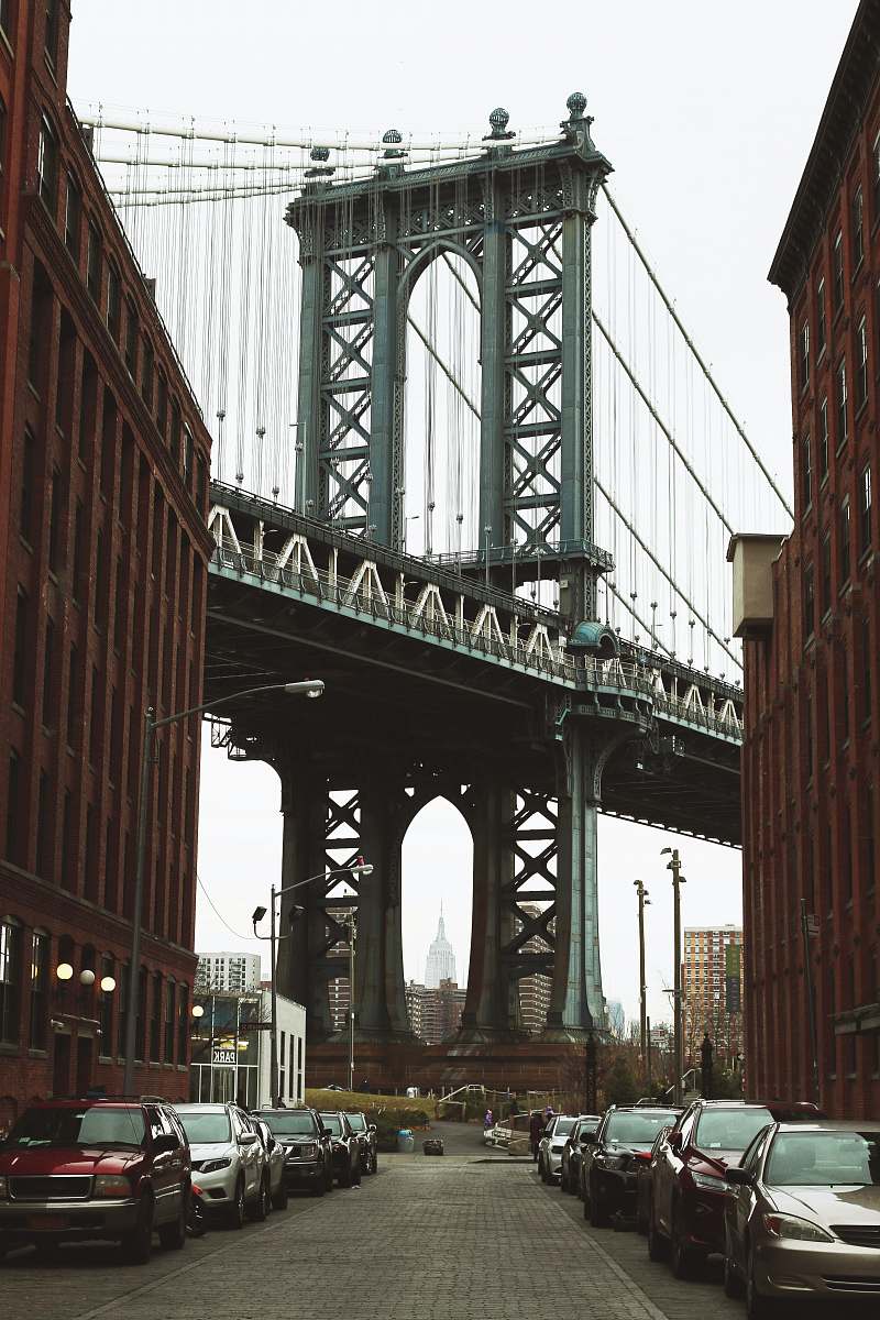 dumbo vehicles parked along the road near metal bridge parking